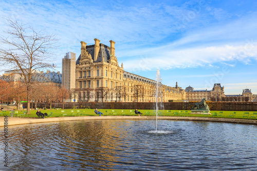 PARIS, FRANCE - DECEMBER 9, 2014: A water fountain in Jardin des Tuileries (Tuileries garden) & Orangerie - favorite spot for rest of tourists and Parisians. People hang out around pool in the park. 