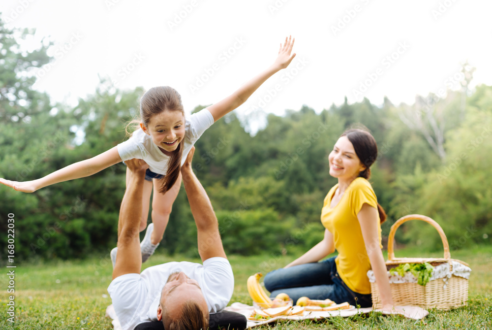 Fototapeta premium Adorable girl little pretending to be airplane