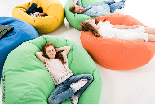 family on bean bag chairs after shopping