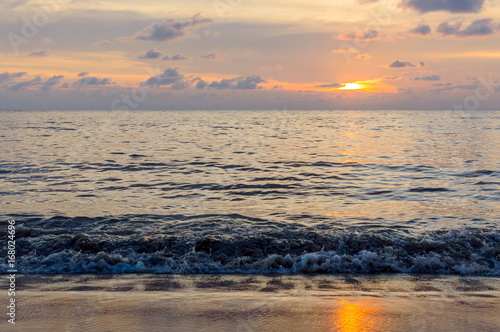 Golden sunrise sunset over the sea ocean waves