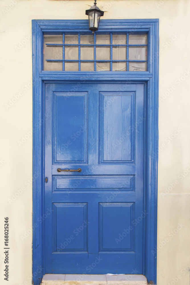 Vintage blue wooden door in village of Greece