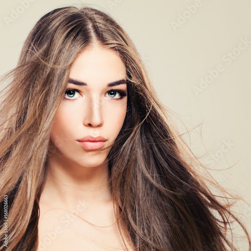 Pretty Young Woman with Perfect Skin and Long Healthy Hair. Beautiful Woman, Skin and Hair Care Concept