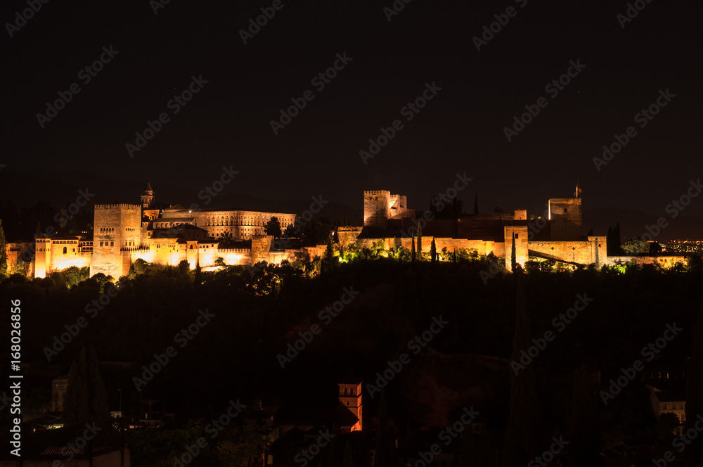 panoramic view at night on the Alhambra's complex illuminated in Granada, Spain