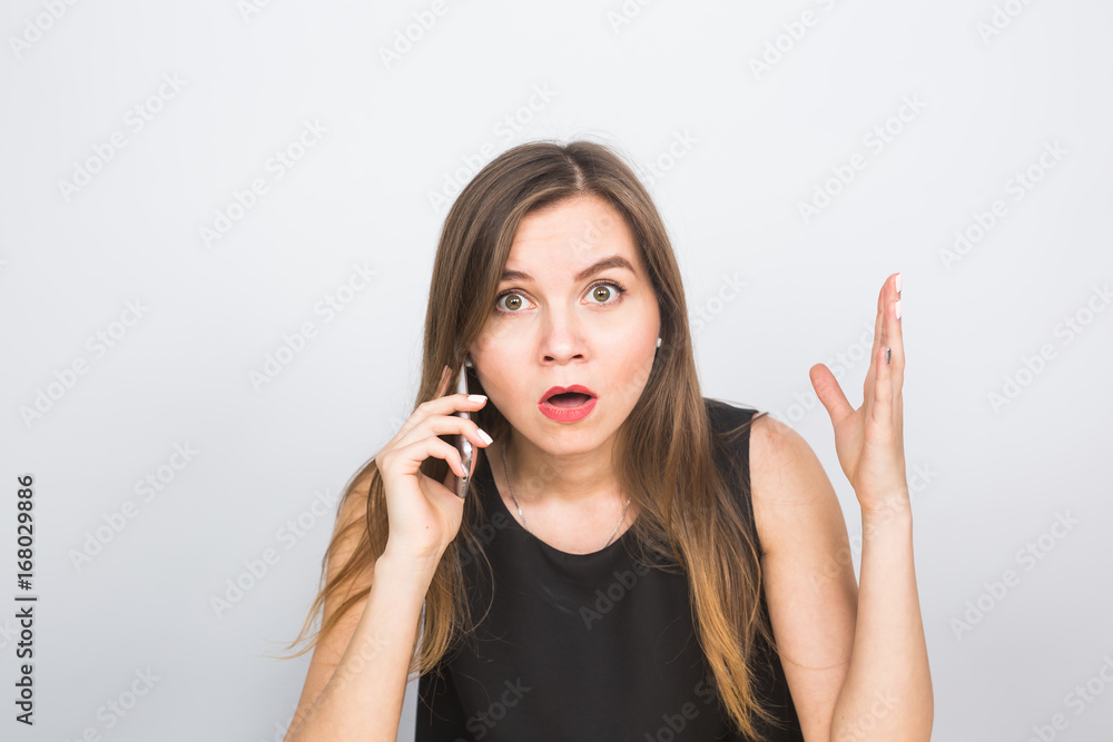 Surprised young businesswoman talking on the mobile phone Surprised young businesswoman talking on the mobile phone