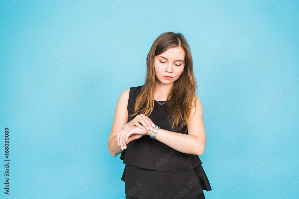 Time is over. Attractive brunette woman pointing to her hand reminding about time Time is over. Attractive brunette woman pointing to her hand reminding about time
