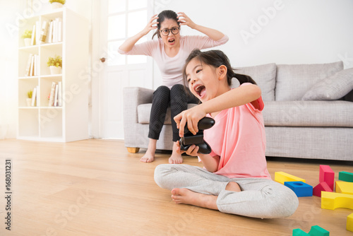children holding controller playing video games
