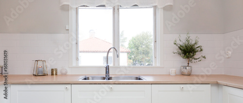 Canvas Print panorama of kitchen sink and kitchen counter top by the window in fancy kitchen