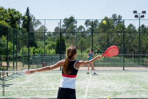 Obraz na plátně Two women playing padel outdoor
