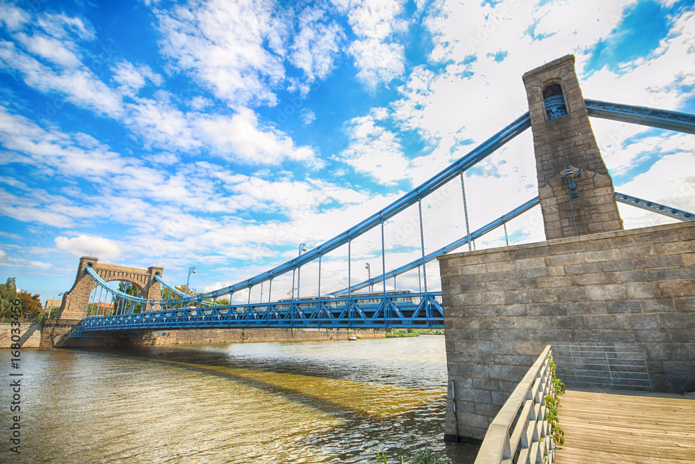 Fototapeta premium WROCLAW, POLAND - AUGUST 14, 2017: Grunwald Bridge (Most Grunwaldzki) is a suspension bridge over the river Oder in Wroclaw, built between 1908 - 1910. Designed by Richard Pluddemann.
