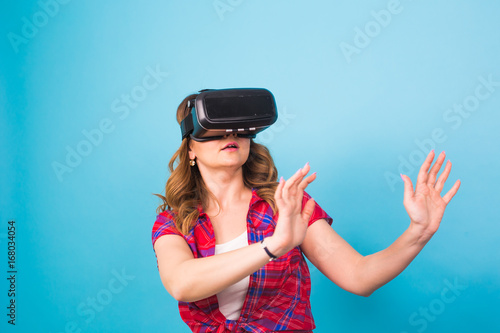 Happy young woman using a virtual reality headset. © satura_