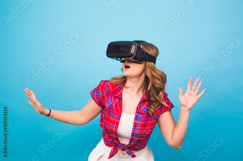 Happy young woman using a virtual reality headset.