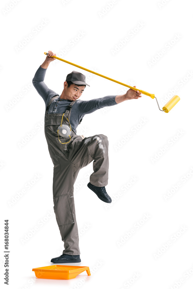 Obraz premium construction worker with roller brush