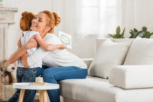 mother and daughter hugging each other