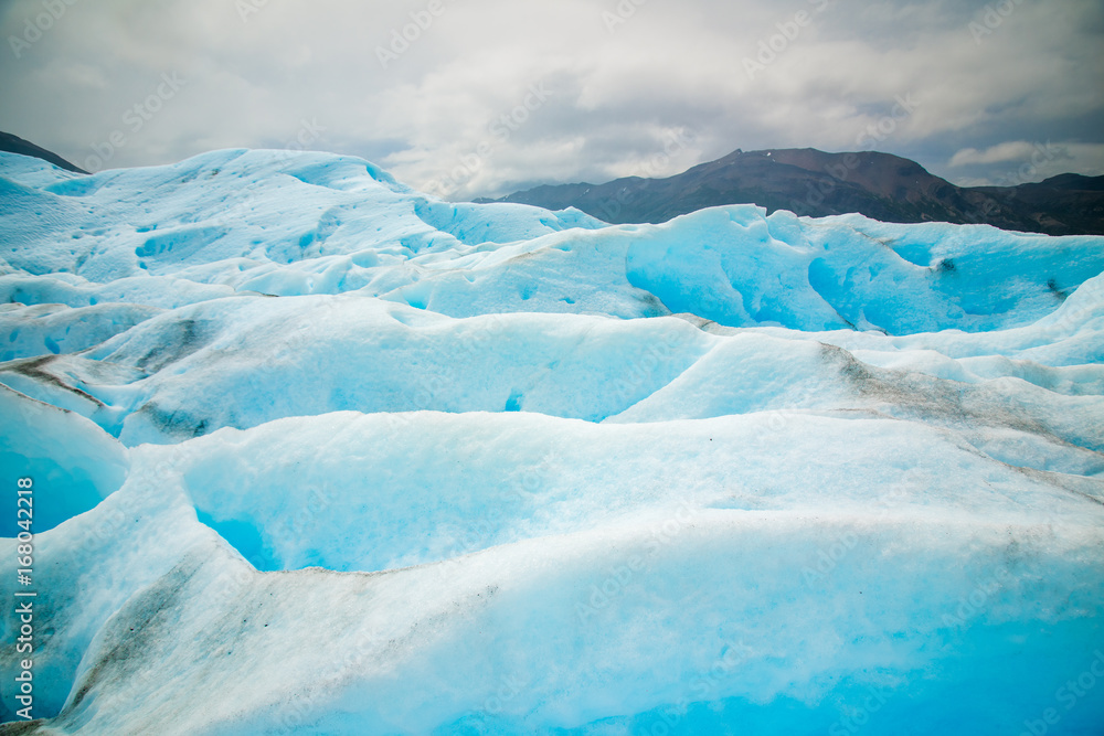 Snowy slopes against the backdrop of the mountains. Shevelev.