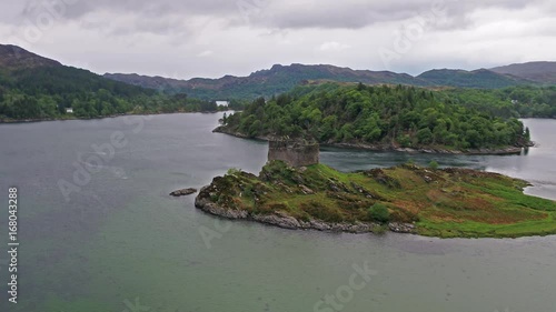 Aerial view of the old ruined Castle in the Highlands of Scotland - Long distance flight part 02 photo