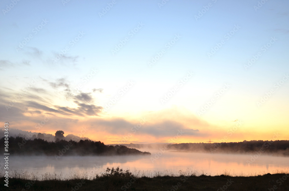 Foggy river at sunset