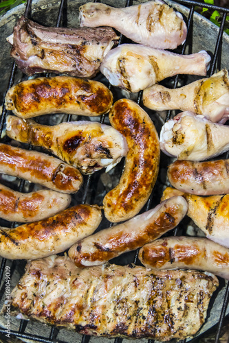 Sausages pork ribs chicken legs on the grill barbecue