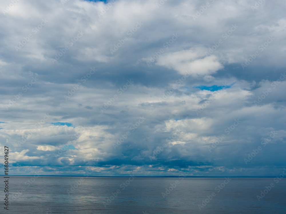 Gloomy clouds hovered over the surface of the sea
