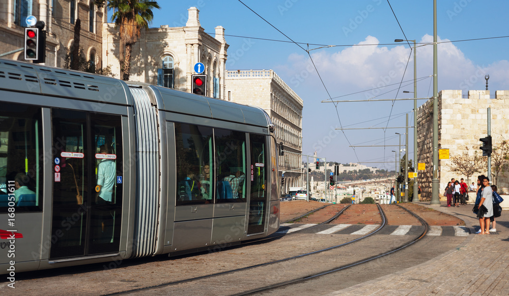 Modern tram goes along the street of Jerusalem.