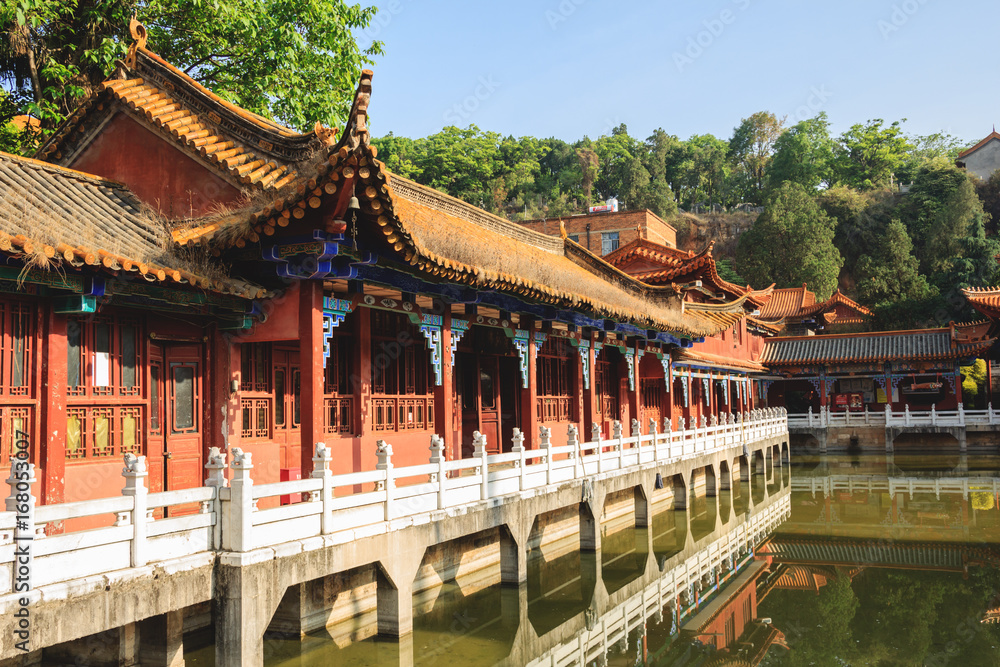 Traditional Chinese Buddhist temple with a pond