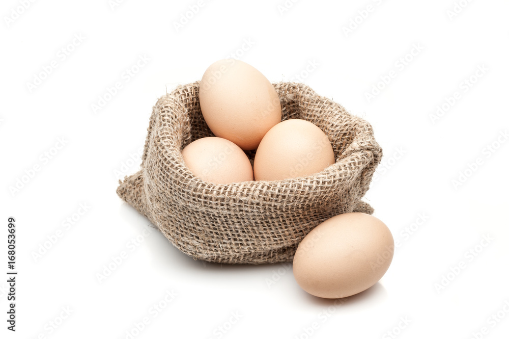 chicken eggs in burlap sack isolated on white background chicken eggs in burlap sack isolated on white background