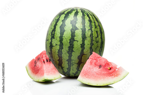 watermelon with one slice standing isolated on white background