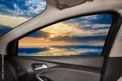 clouds and water surface from car window © Yuri Bizgaimer