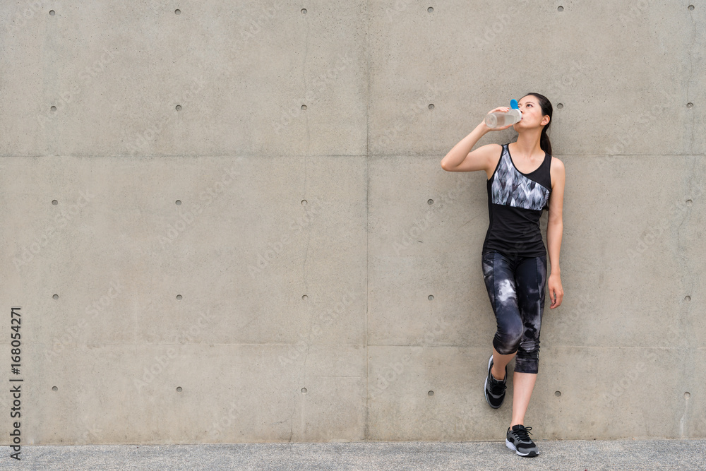 exercise woman drinking water after jogging