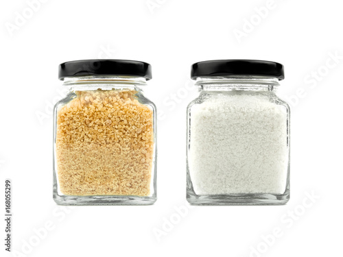 Fotografie Brown sugar and salt set in a glass bottle isolated on white background