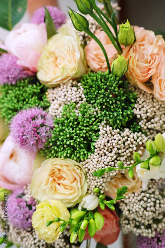 Assembled bouquet in wowen box with roses and peonies photo