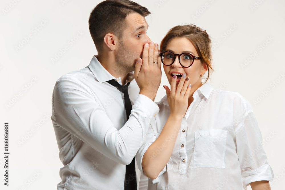 The business man and woman communicating on a gray background The business man and woman communicating on a gray background