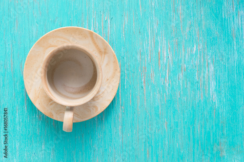 Coffee cup on rustic wood background.