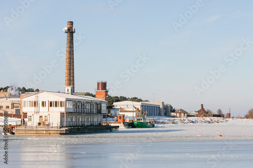Small countryside frozen ship port near baltic sea.