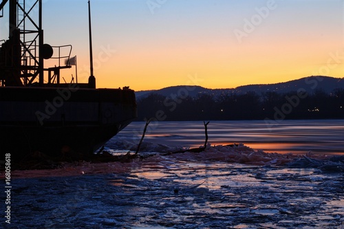 Frozen river Danube with old ship. photo