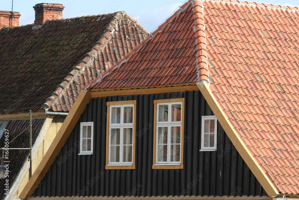 Obraz premium Historic house rooftop with small windows.