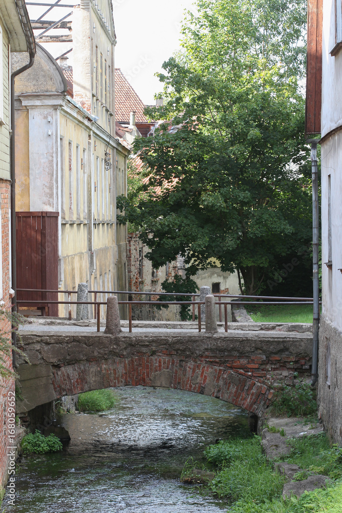 Small river going through small countryside city.