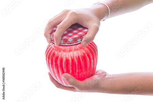 Close up of hands opening a jar.