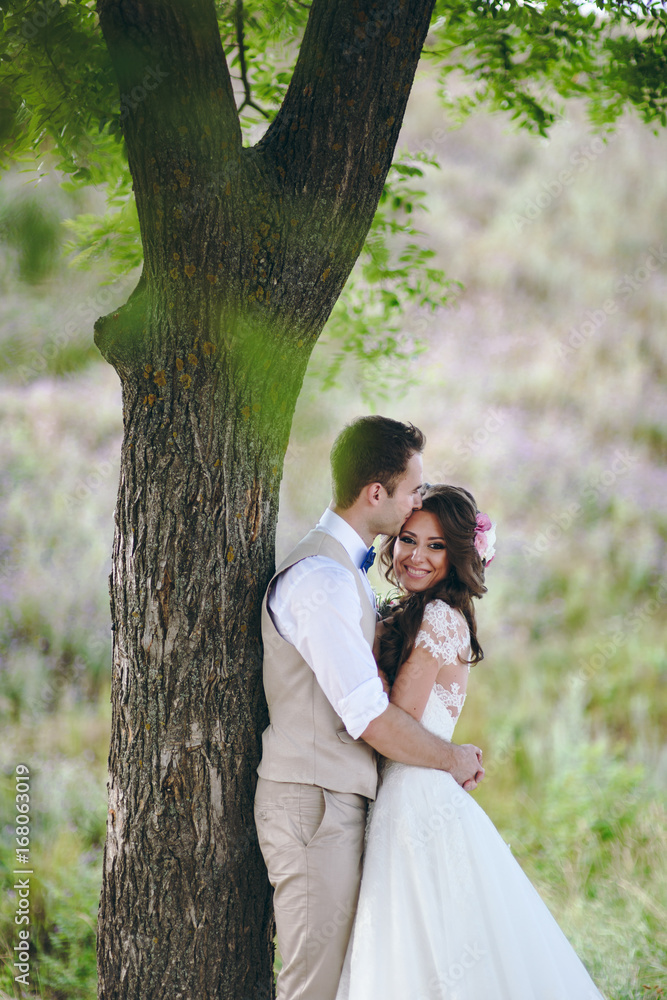 Fototapeta premium Beautiful bride and groom couple walking at the wedding