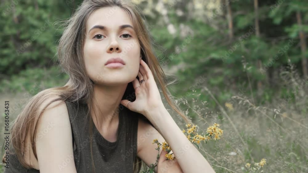 outdoor portrait of a beautiful middle aged woman sensual. attractive sexy girl in a field with flowers outdoor portrait of a beautiful middle aged woman sensual. attractive sexy girl in a field with flowers