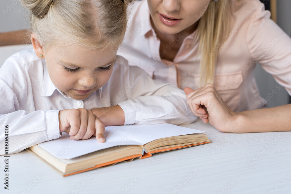 mother and daughter reading book mother and daughter reading book