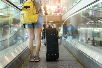 Young girl asian traveler walking with carrying hold suitcase luggage and passenger for tour travel booking ticket flight in airport international vacation time in holiday rest and relaxation.