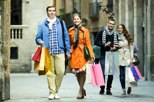 Group of young tourists with purchases