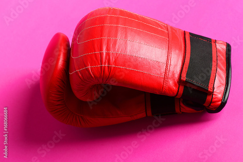 Bright red boxing sport gloves with stripes isolated on pink © be free