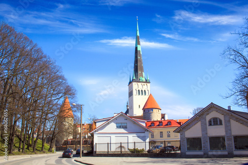Beautiful view of the tower Oleviste Churchand the Fortress wall in Tallinn, Estonia, on a sunny day