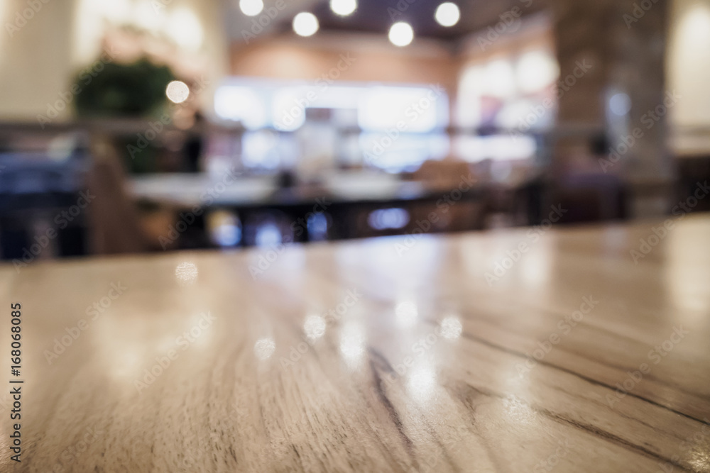 Empty wood table top with blurred cafe restaurant coffee shop interior background