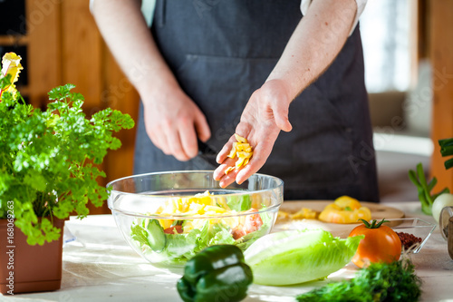 Chef cutting fresh and delicious vegetables for salad