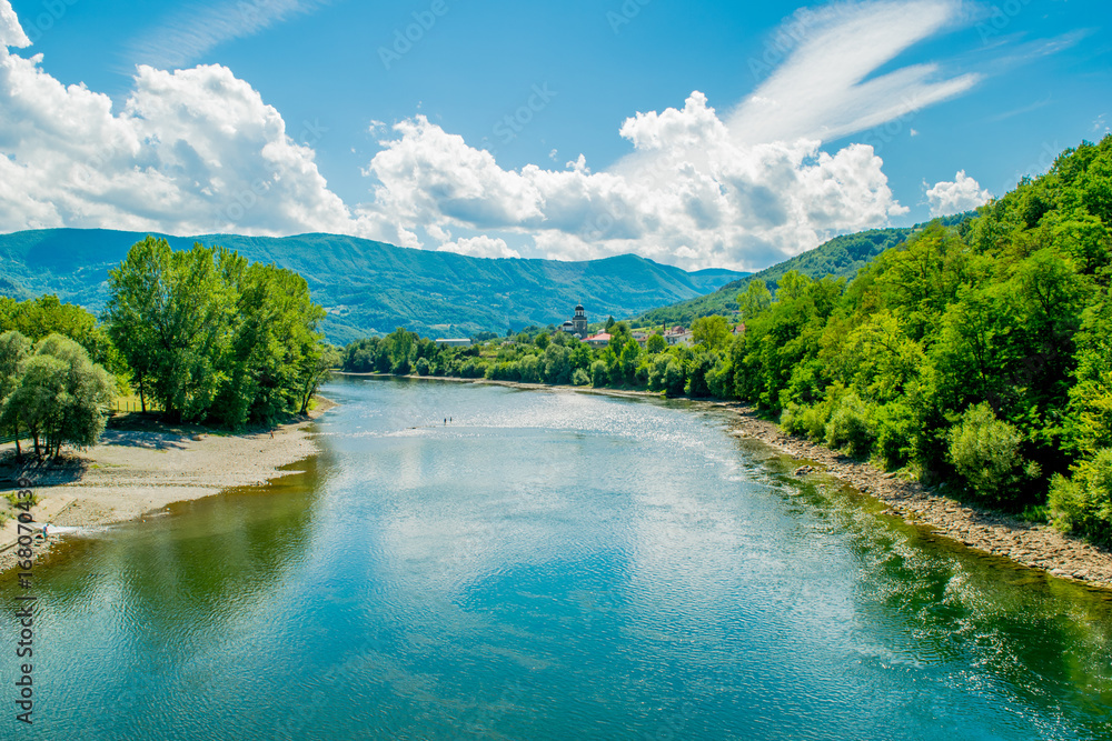 Majestic look to the River in eastern Serbia. Beautiful landscape include sky, clouds, mountains, river, forest, stone coast and reflection.