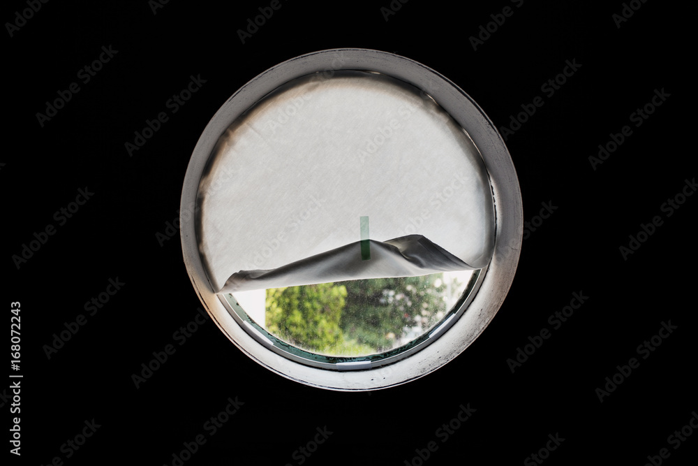 A circular window covered with paper