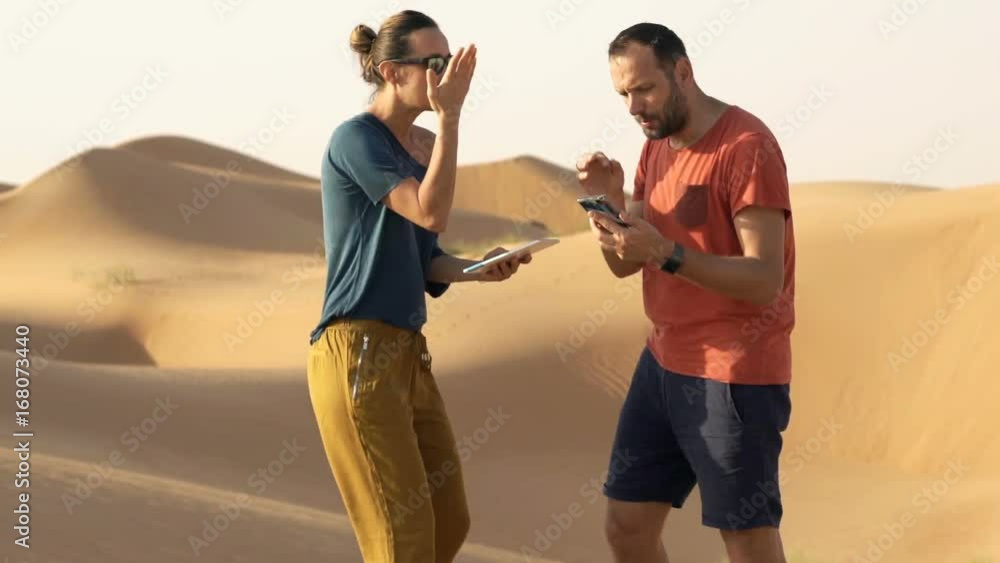 Young couple with tablet and smartphone fighting on dessert
