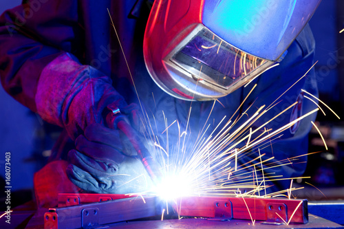 Welder erecting technical steel photo